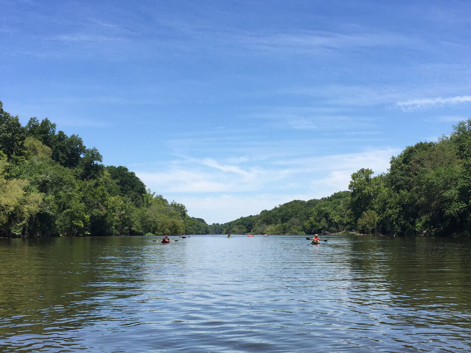 Paddlers and green banks on the Cape Fear River in an undated official USACE project-context photograph.