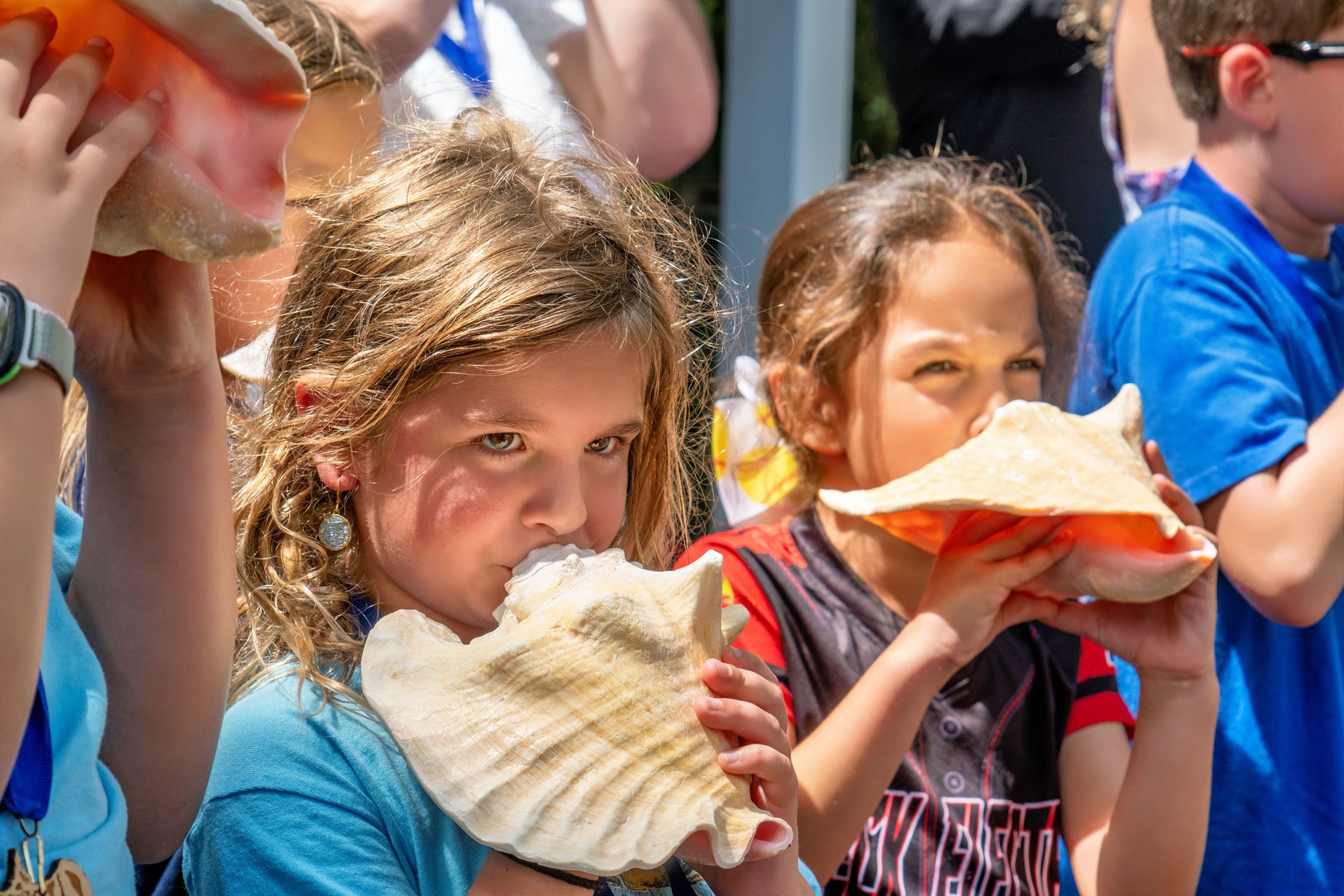 Young contestants take part in the March 7, 2026 Conch Shell Blowing Contest in Key West. The photograph does not identify individual children.